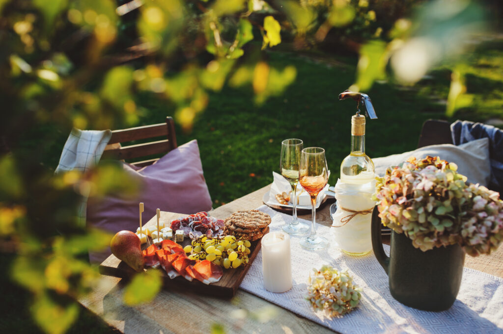 An outdoor springtime garden party featuring charcuterie and rose wine.