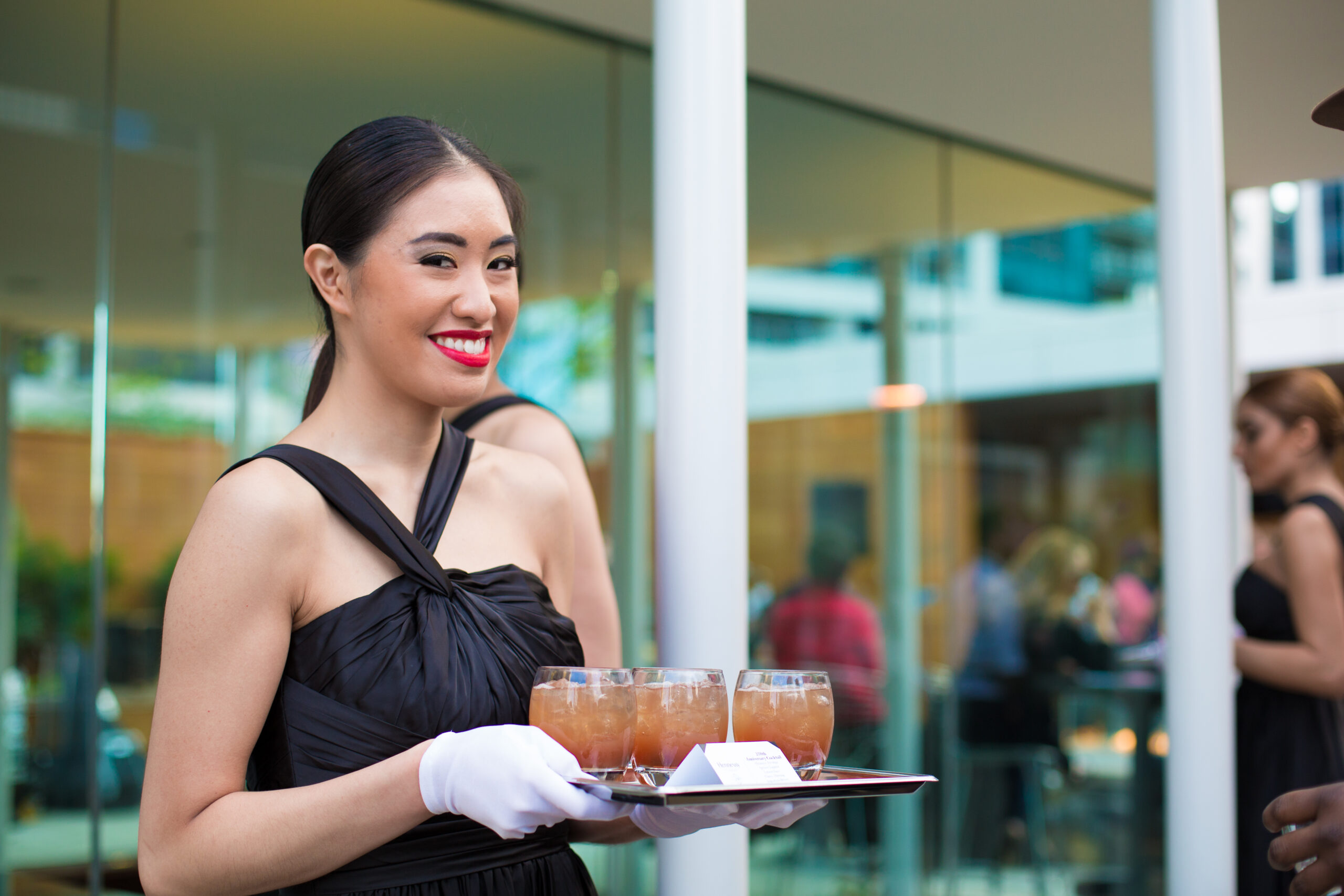 Cater Dallas bartender serving drinks on a tray for DFW Event