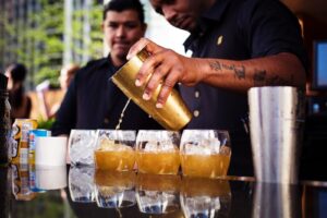 a photo of a man pouring drinks from cater dallas bartending services