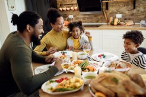 a family gathered around a table enjoying a thanksgiving meal
