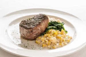 A steak with a side of creamy corn from Silverfox