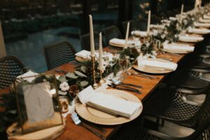 Wedding table setting with gold plates and white linens