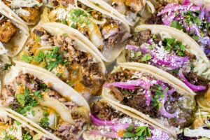 A overhead shot of different variety of soft tacos