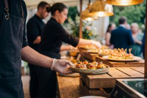 Professional catering staff plating and serving for outdoor event