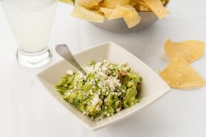 Cantina Laredo guac image with a side of chips